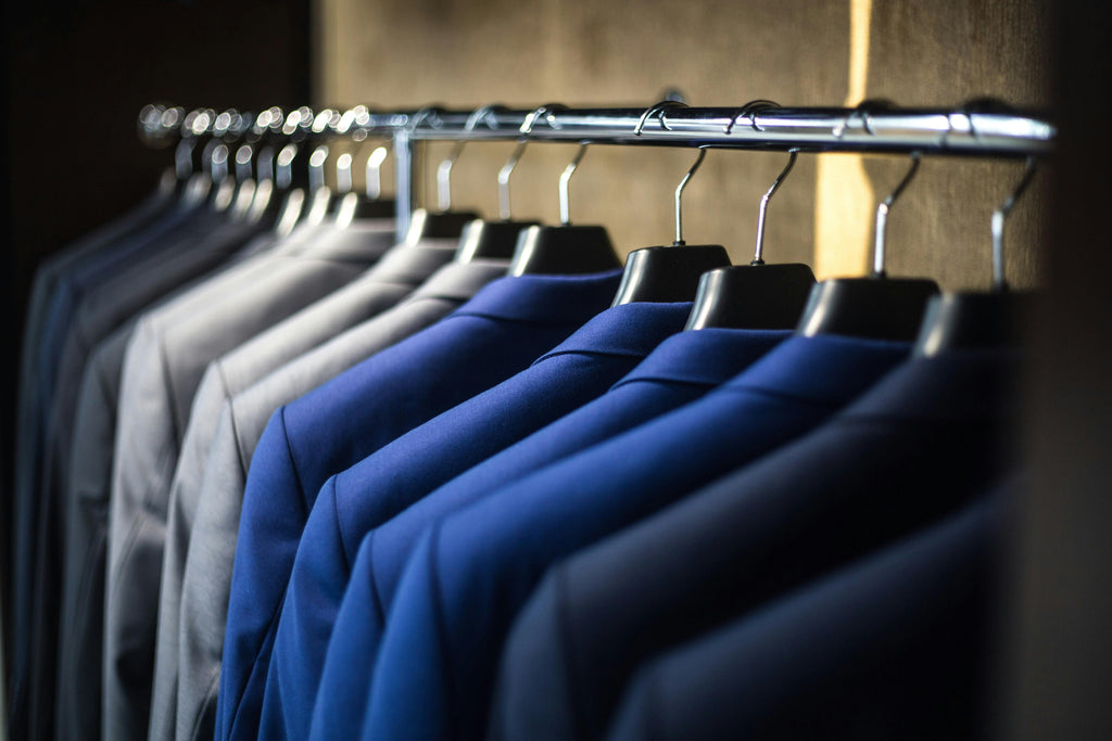 Rack of suit coats organized by color