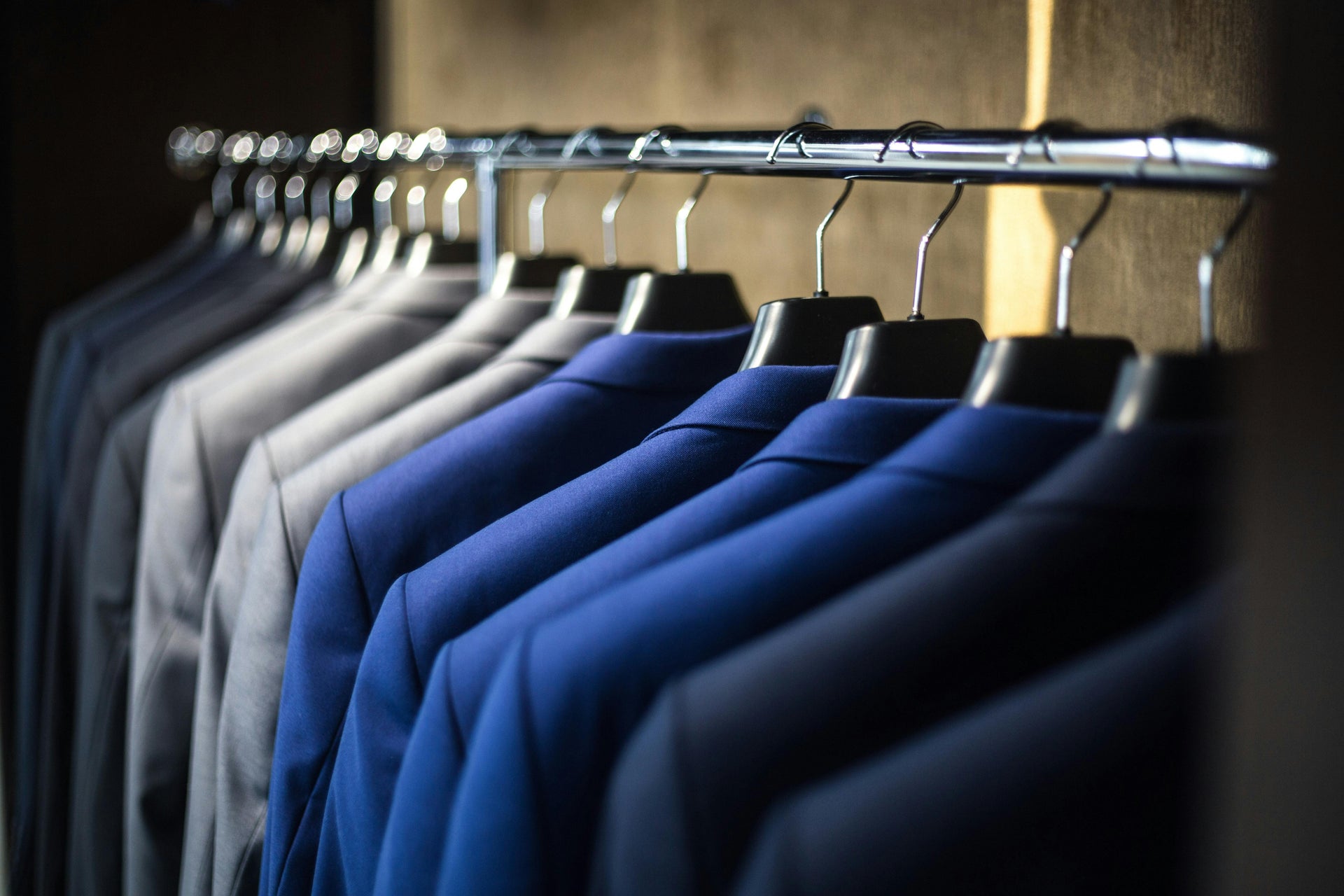 Rack of suit coats organized by color