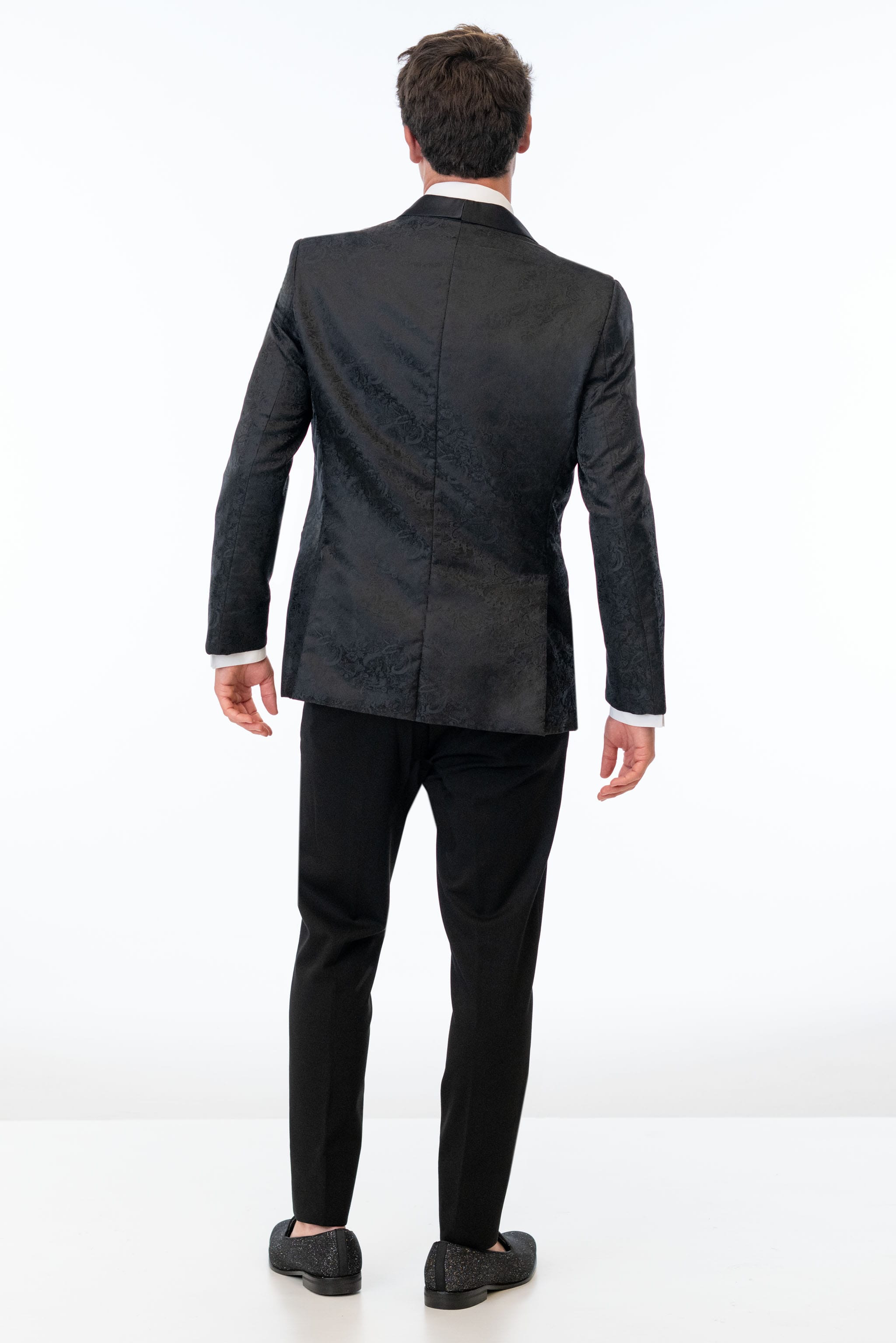back view of man wearing Black Paisley Slim Fit Tuxedo coat with black pants 