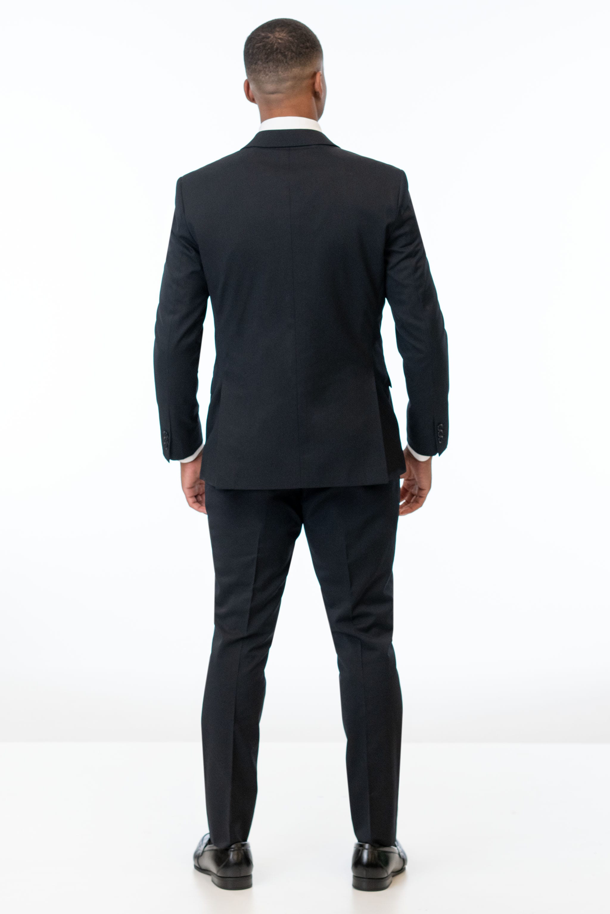 back view of man wearing Black Performance Stretch Slim Fit Suit 