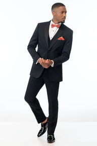 Man wearing Black Performance Stretch Tuxedo with a sedona colored bow tie on a white background