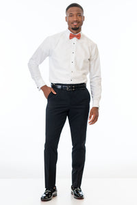 Man wearing Black Performance Stretch pants, white shirt, and bow tie on a white background