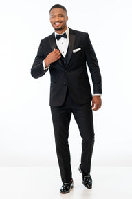 Man wearing Black Stretch Tuxedo with a white shirt and black bow tie on a white background