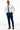 man wearing Blue Performance Stretch Slim Fit Suit pants, white shirt, and emerald green tie