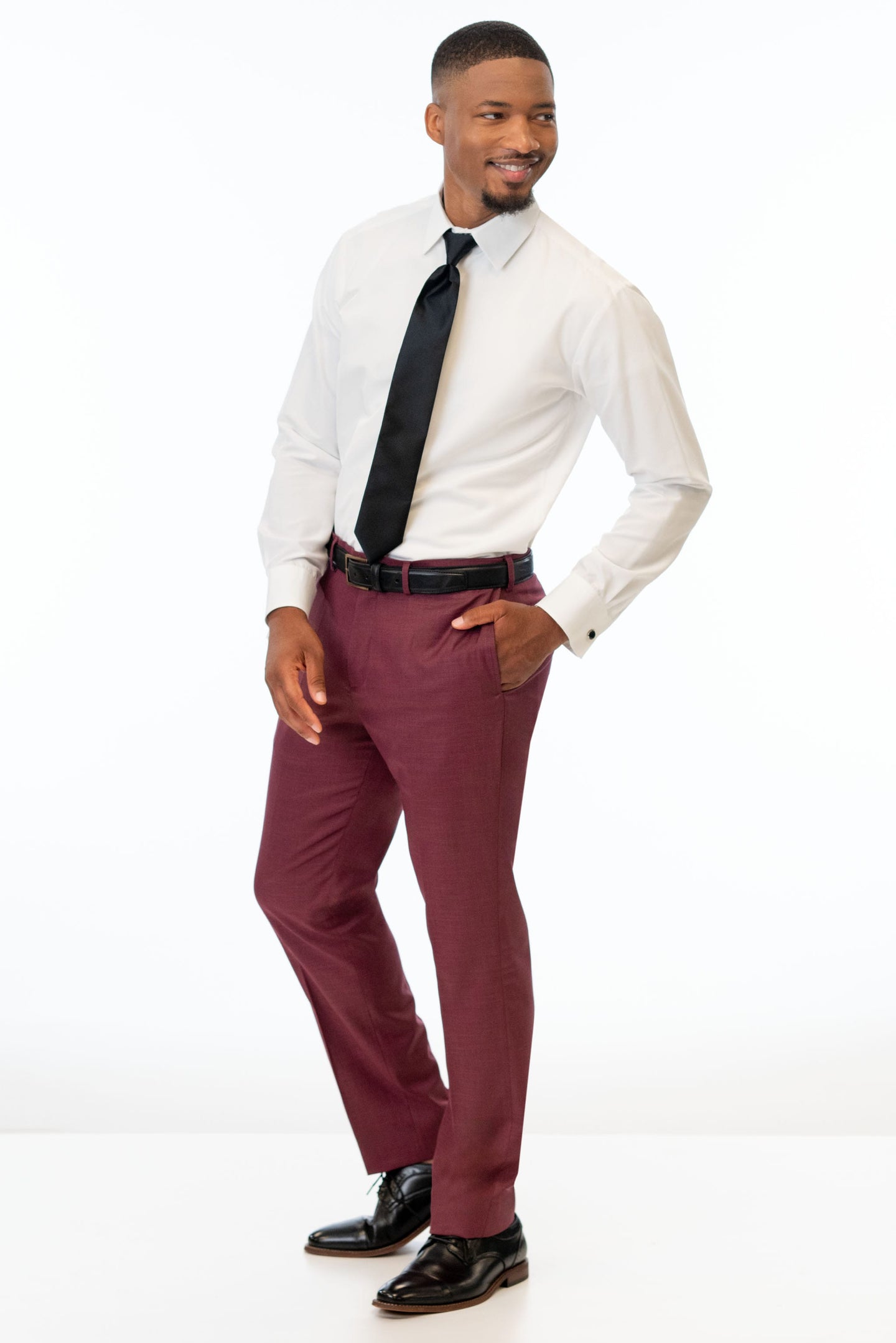 man wearing Brick Stretch Slim Fit Suit pants, white shirt, and black tie