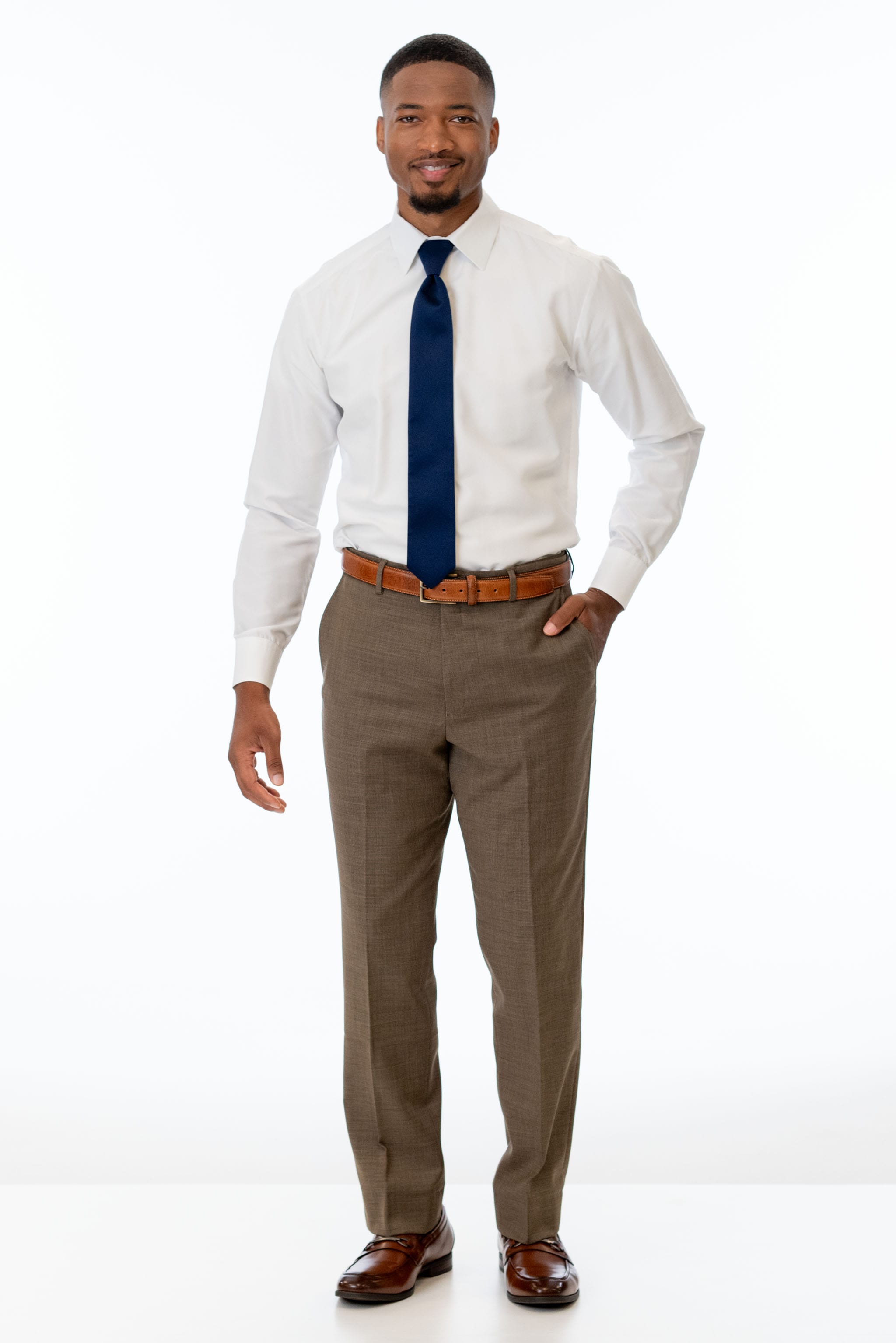 man wearing Brown Archer Slim Fit Suit pants, white shirt, and navy blue tie