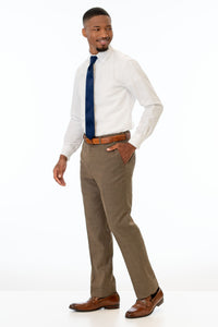 side view of man wearing Brown Archer Slim Fit Suit pants, white shirt, and navy tie