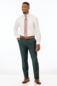 man wearing Dark Green Stretch Slim Fit Suit pants, white shirt, and pink tie