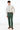 man wearing Forest Green Stretch Slim Fit Suit pants, white shirt, and floral green tie