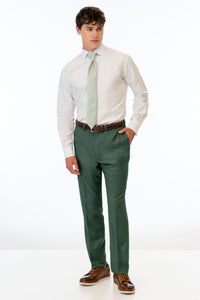 man wearing Forest Green Stretch Slim Fit Suit pants, white shirt, and floral green tie