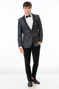 Man wearing Granite Paisley Tuxedo jacket, black pants, white shirt and black bow tie on a white background