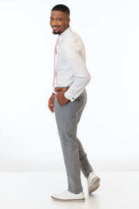 side view of man wearing Heather Grey Clayton Slim Fit pants, white shirt, and windsor tie