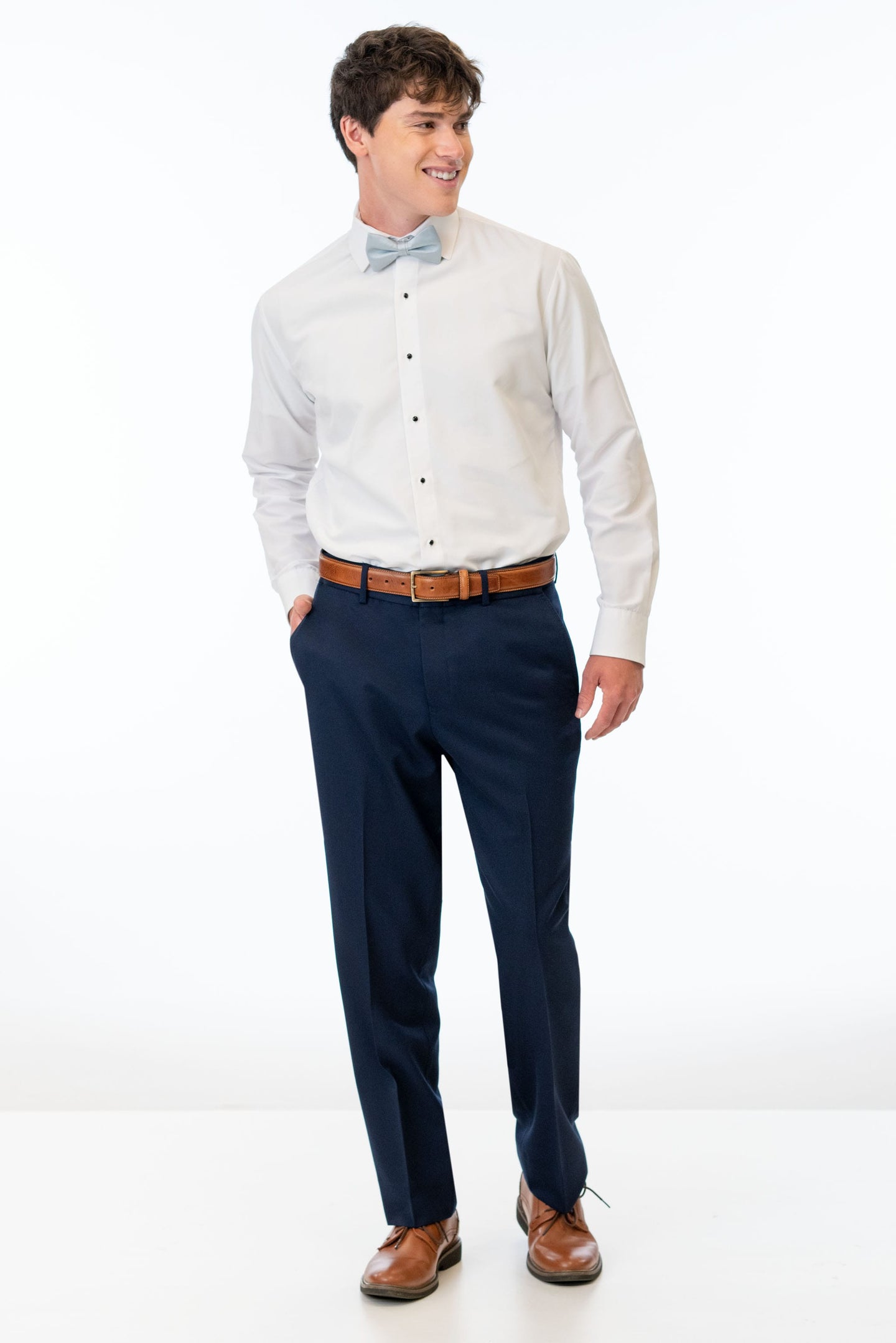 man wearing Navy Sterling Slim Fit Suit pants, white shirt, and bow tie