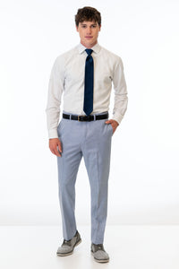 man wearing Oxford Blue Stretch Slim Fit Suit pants, white shirt, and navy blue tie