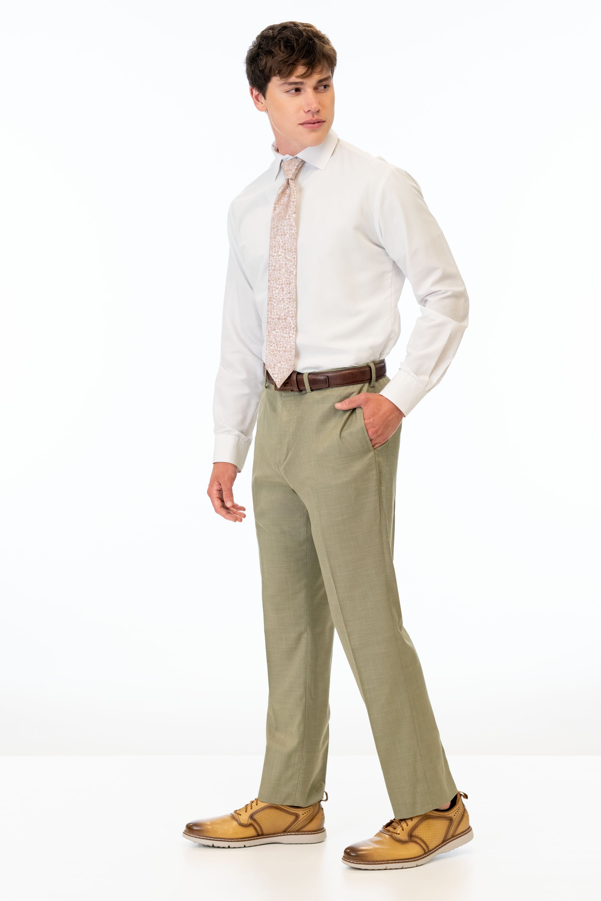 side view of man wearing Sage Green Stretch Slim Fit Suit pants, white shirt, and pink tie