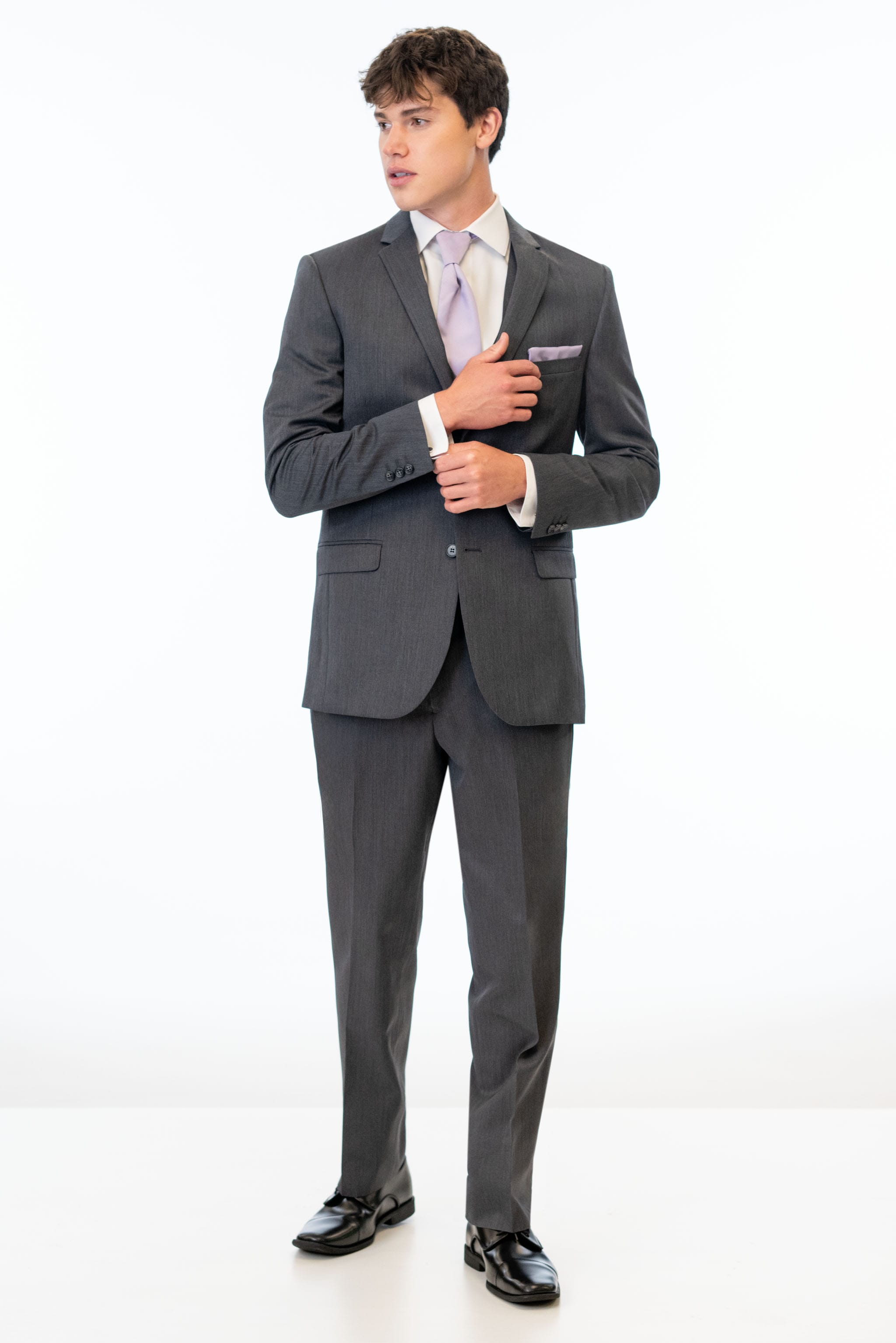 Man wearing a Steel Grey Sterling suit with a white shirt and black shoes on a white background