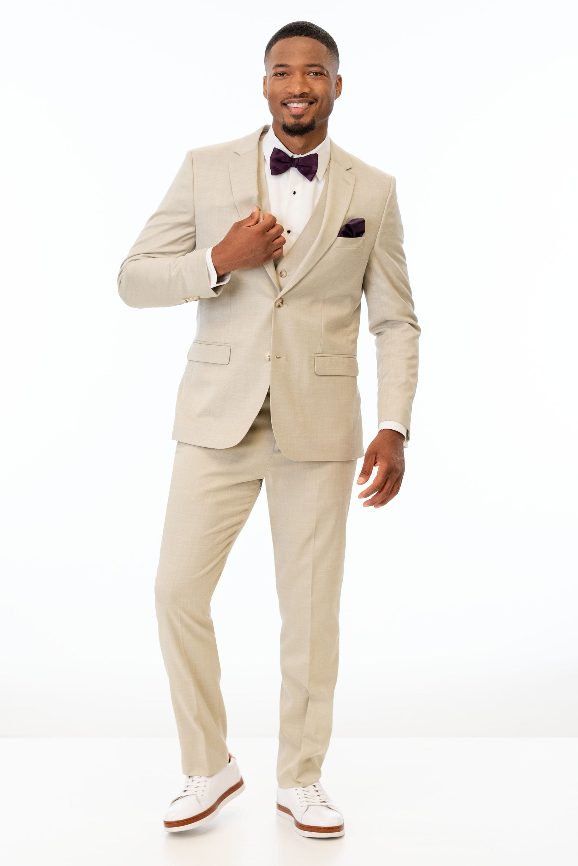 man wearing Tan Stretch Slim Fit Suit with white shirt and bow tie