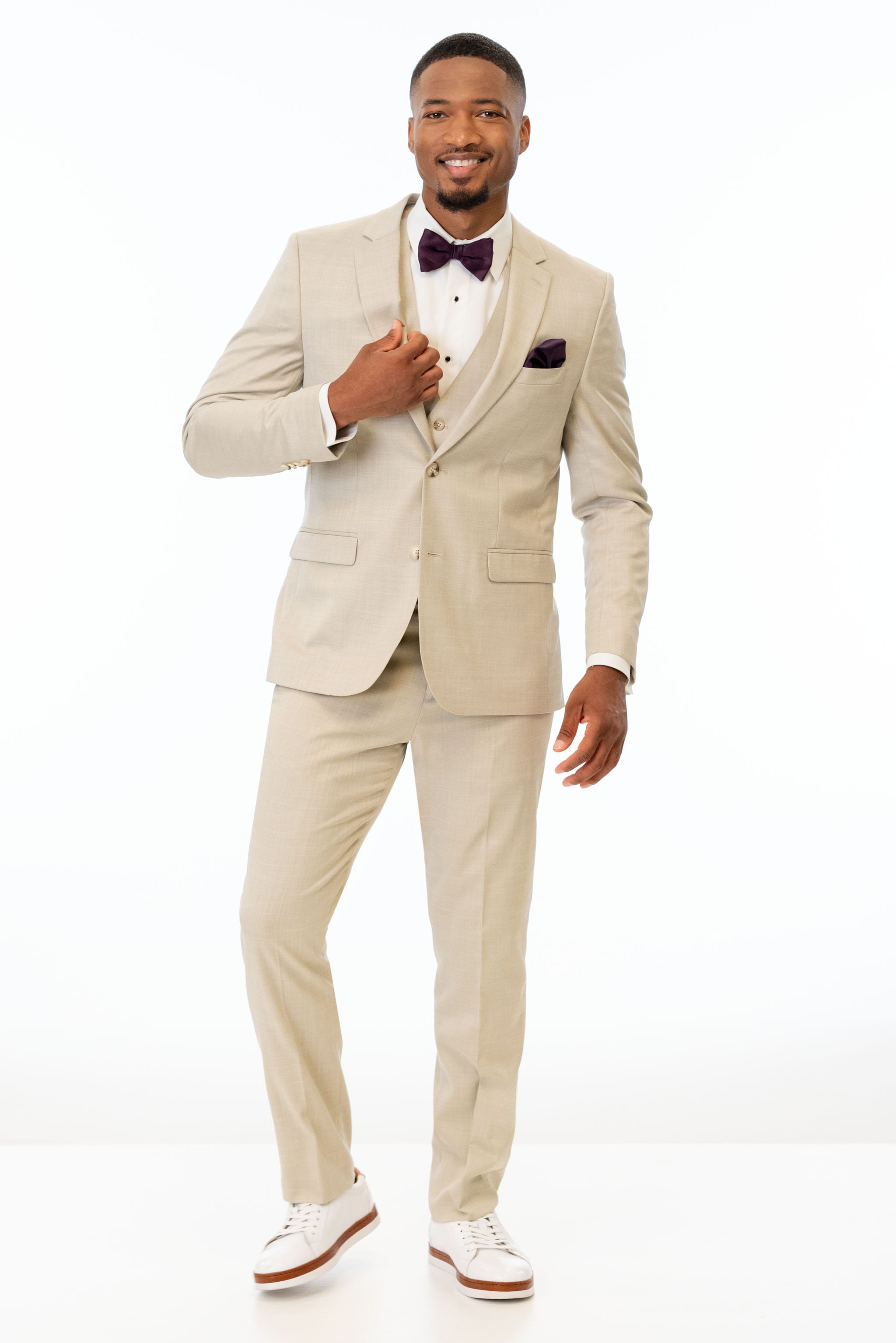 man wearing Tan Stretch Slim Fit Suit with white shirt and bow tie