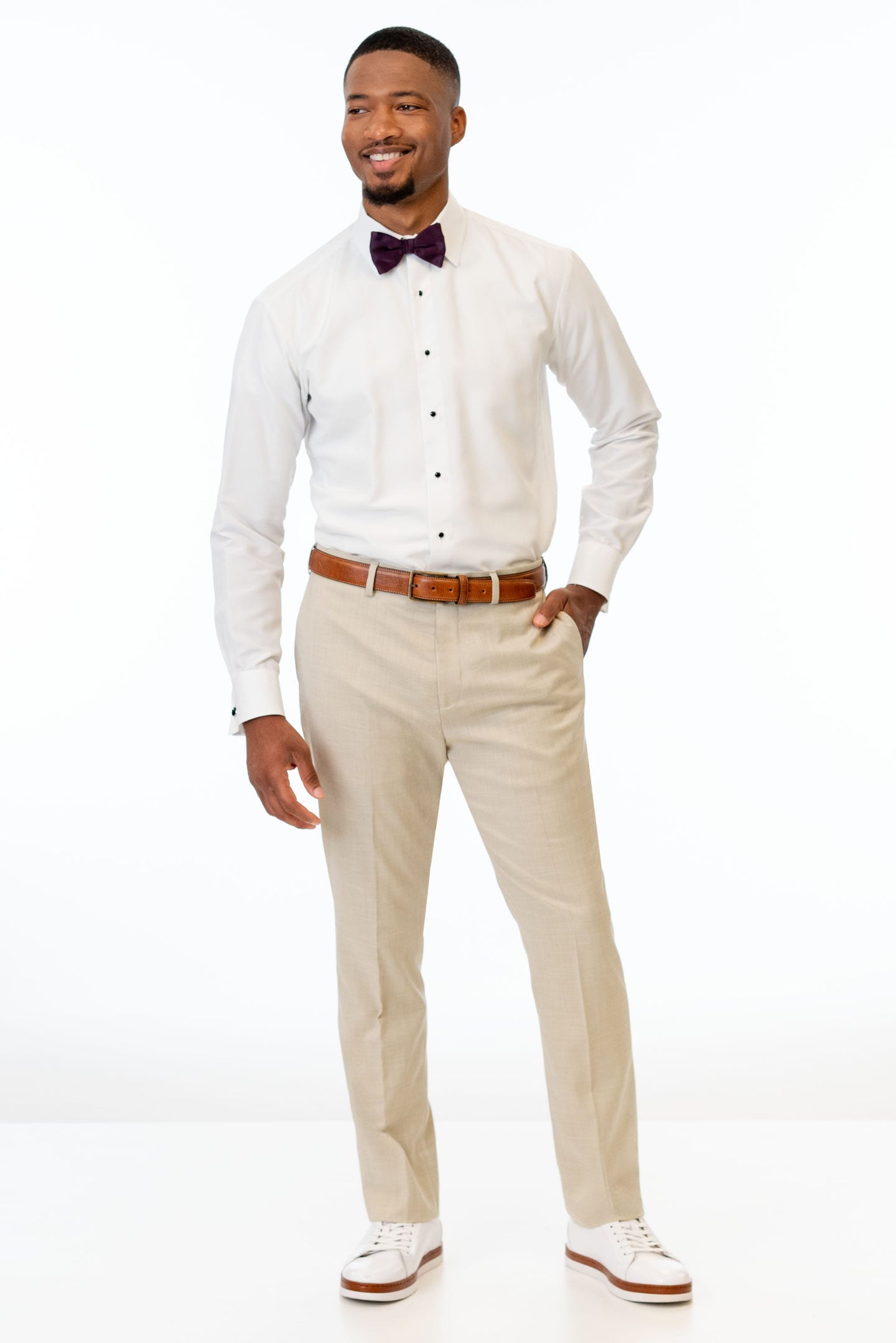 man wearing Tan Stretch Slim Fit Suit pants, white shirt, and bow tie