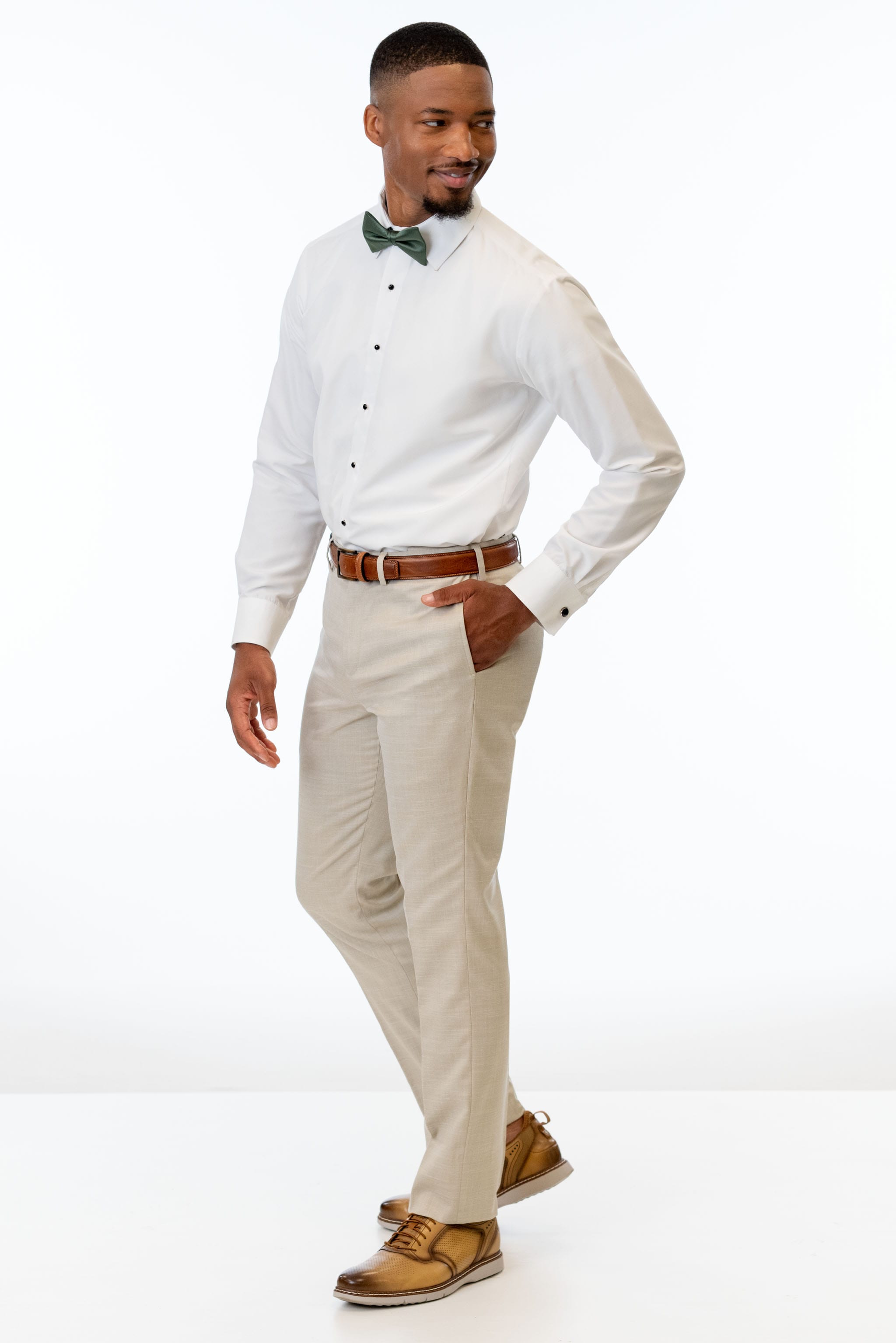 side view of man wearing Tan Performance Stretch Slim Fit Suit pants, white shirt, and bow tie