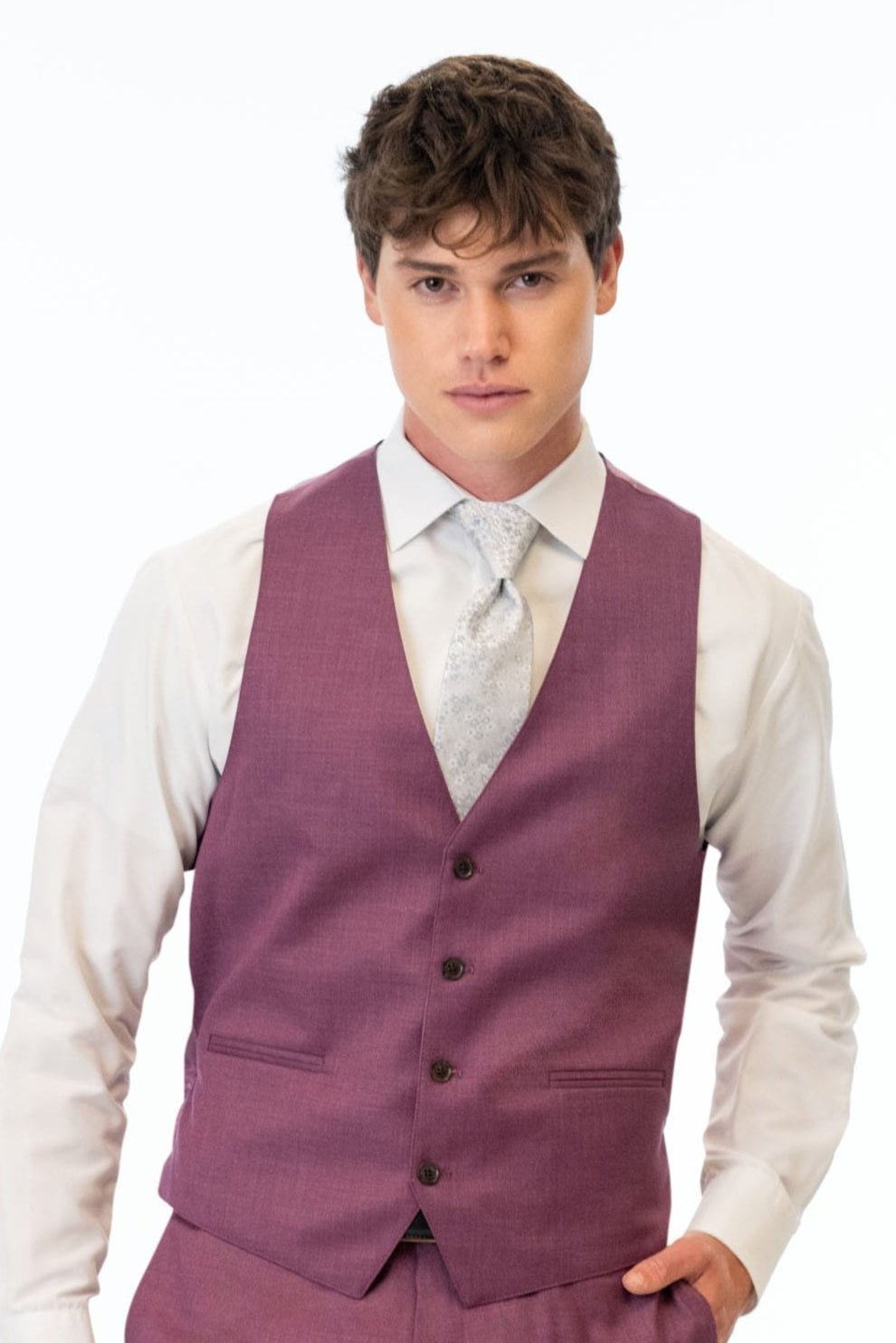 Man wearing a violet vest and pants with a white shirt on a white background