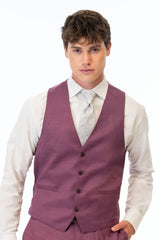 Man wearing a violet vest and pants with a white shirt on a white background