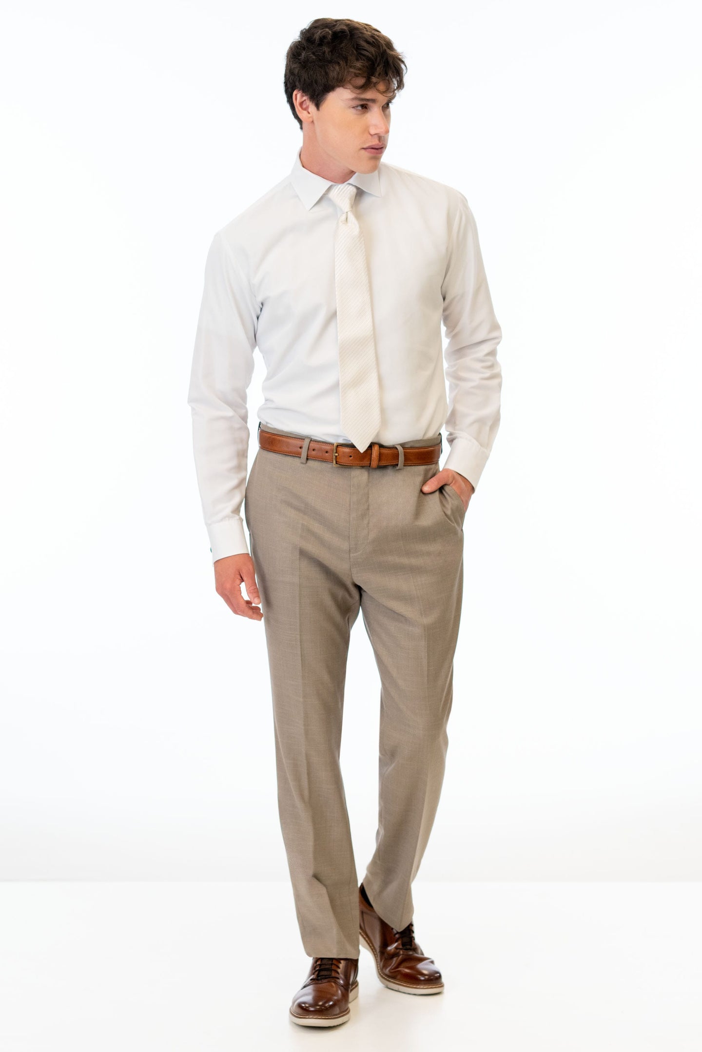 man wearing Wheat Stretch Slim Fit Suit pants, white shirt, and ivory tie