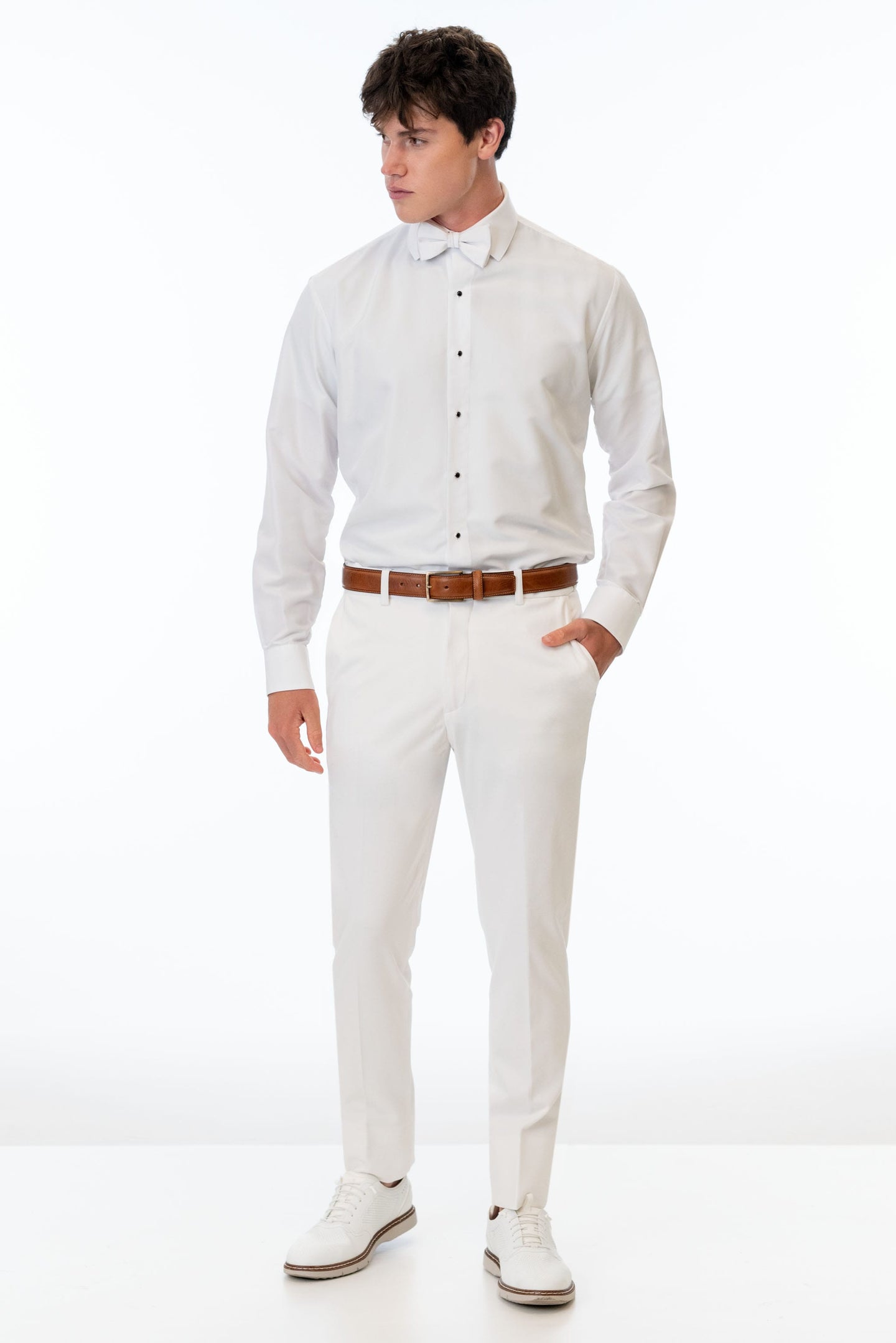 man wearing White Euro Slim Fit pants, white shirt, and bow tie