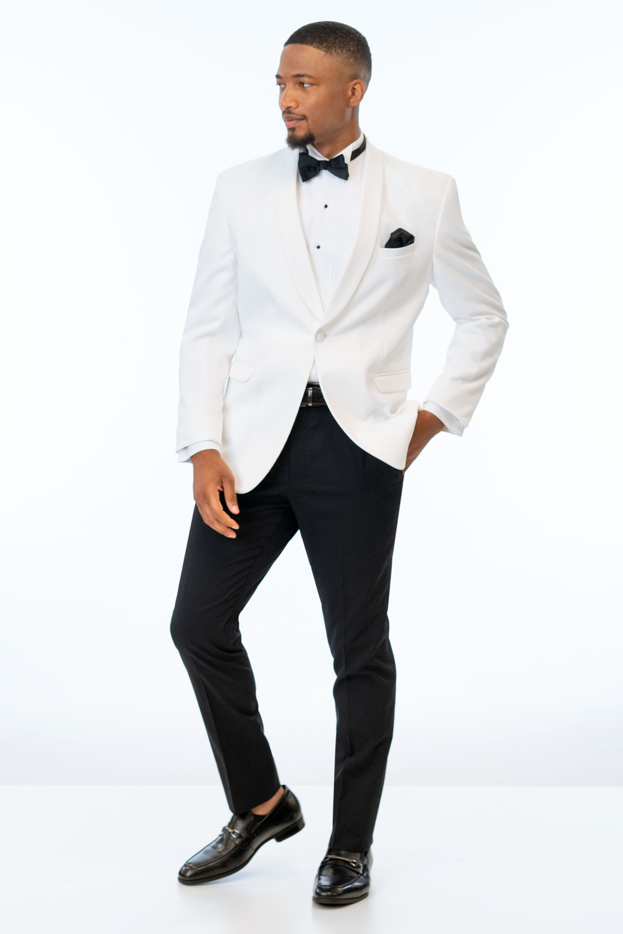 white classic dinner jacket with black pants, white shirt, black bow tie and black loafers
