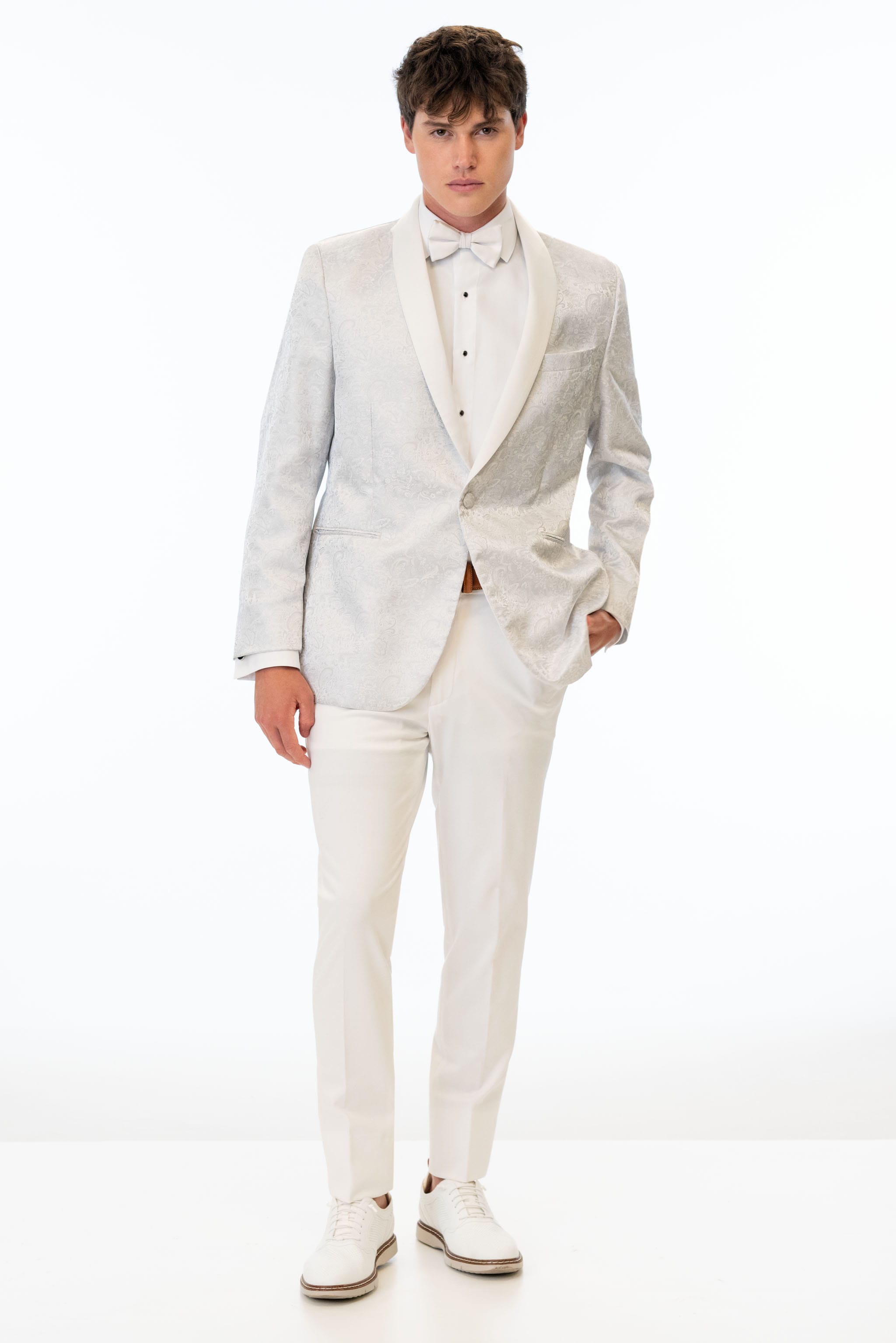man wearing White Paisley Tuxedo coat with White Euro Slim pants and a white shirt and white bow tie