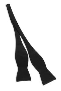 black self tie bow tie lying flat on white background