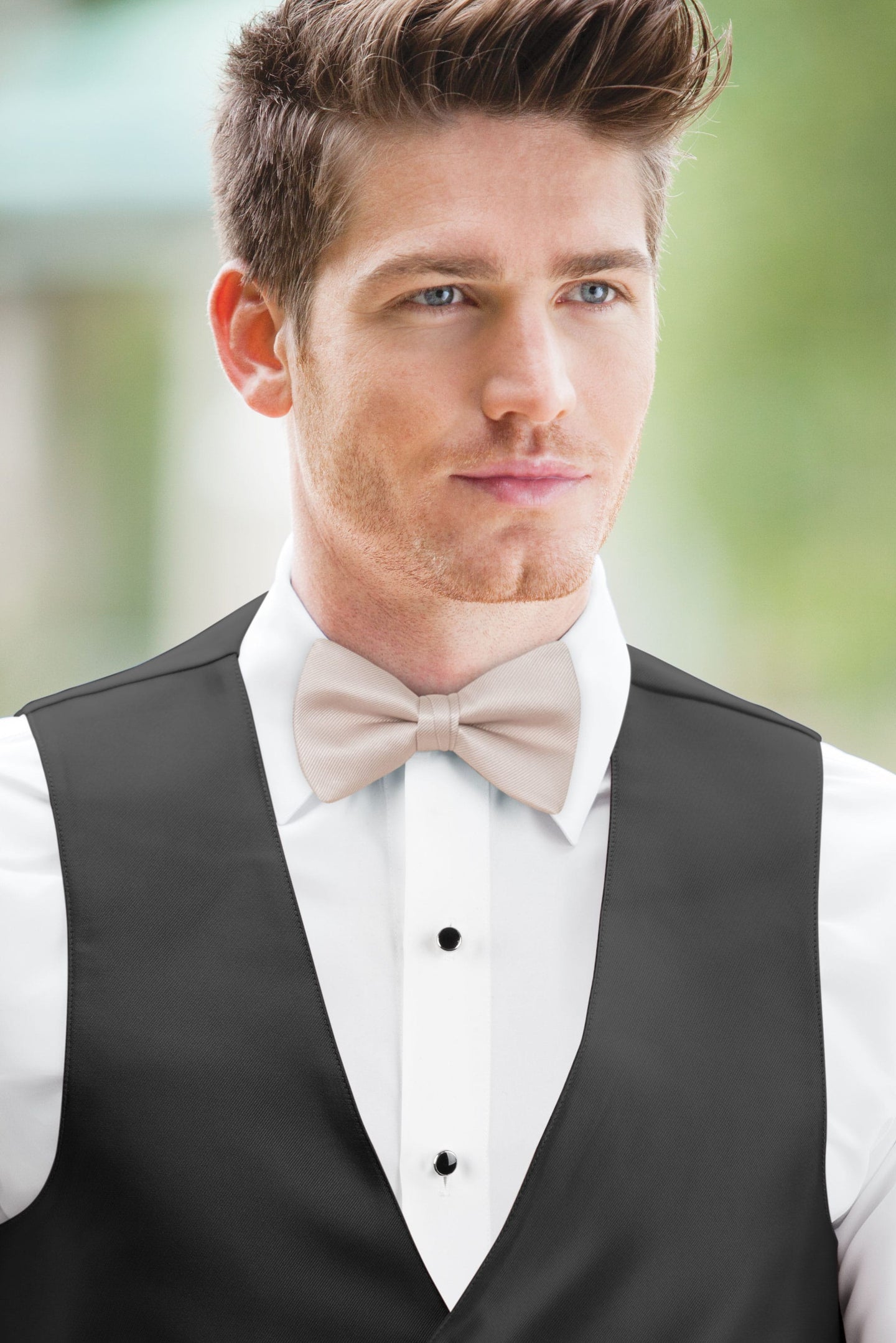 man wearing white shirt, solid blushing pink bow tie, and matching Expressions vest