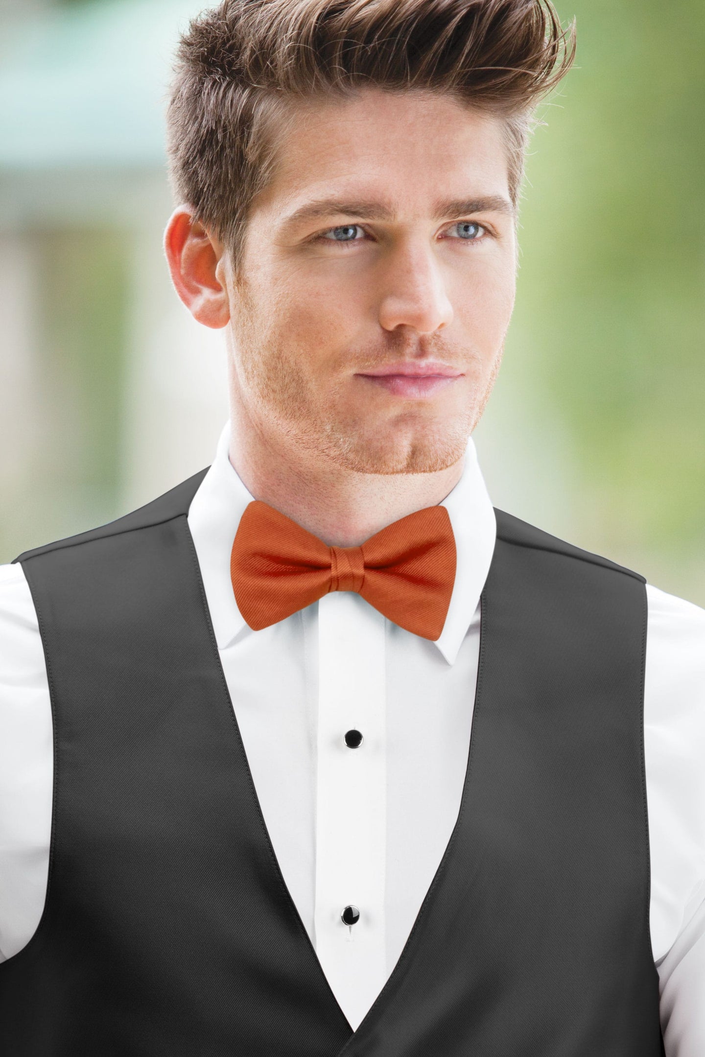 man wearing white shirt, Simply Solids burnt orange bow tie, and black vest