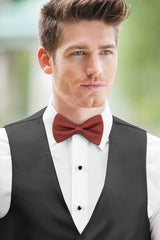 man wearing white shirt, Simply Solids cinnamon bow tie, and black vest