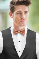 man wearing white shirt, Simply Solids desert coral bow tie, and black vest