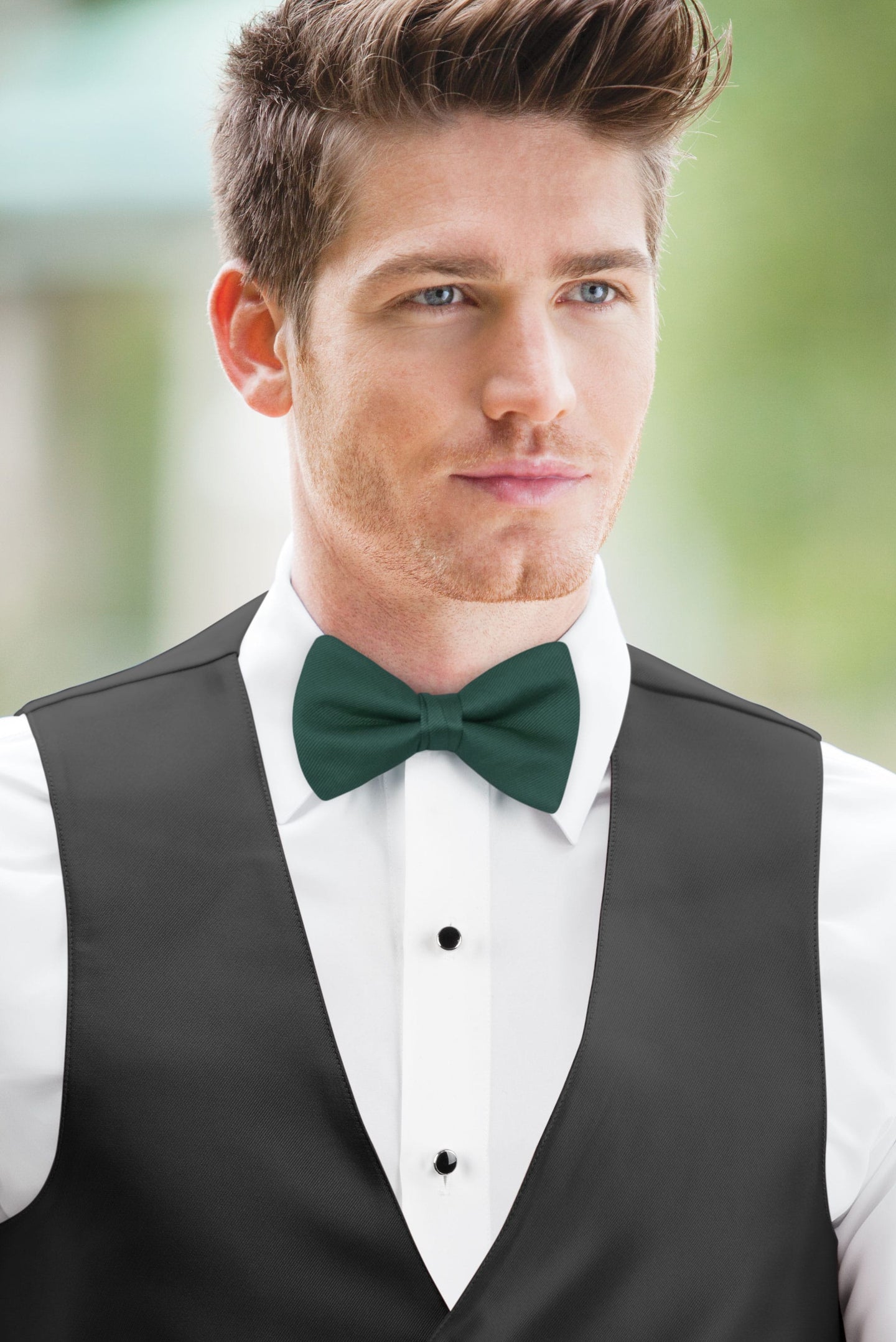 man wearing white shirt, solid forest bow tie, and matching Expressions vest