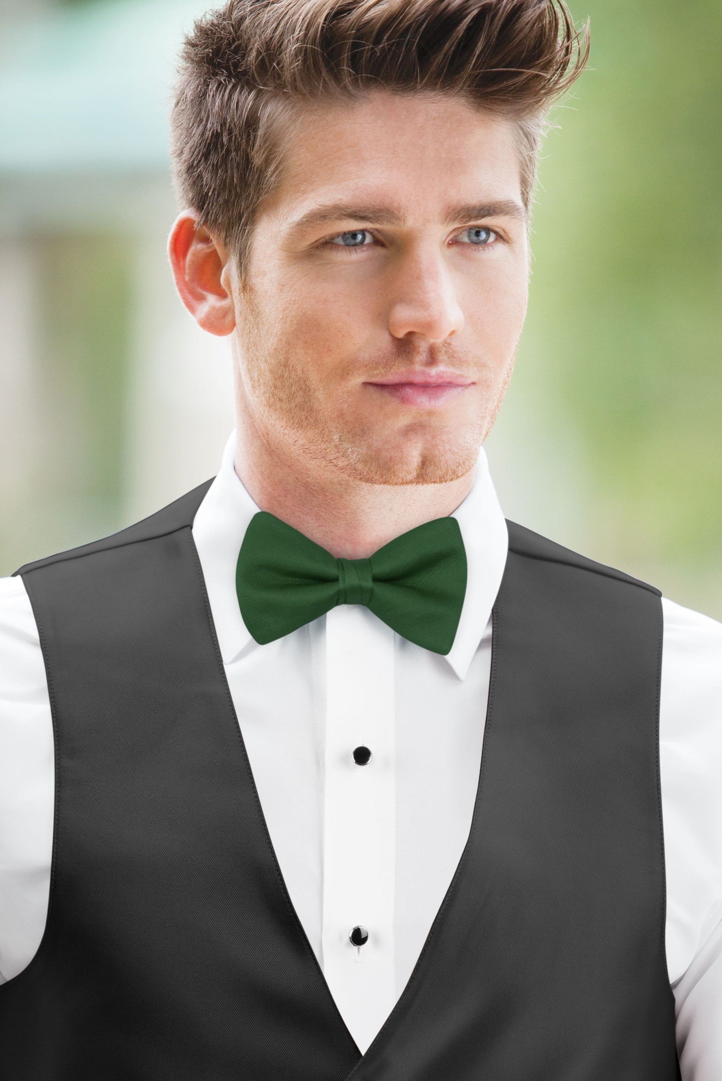 man wearing white shirt, solid hunter green bow tie, and matching Expressions vest