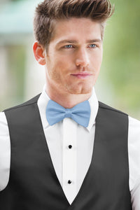 man wearing white shirt, solid lite blue bow tie, and matching Expressions vest