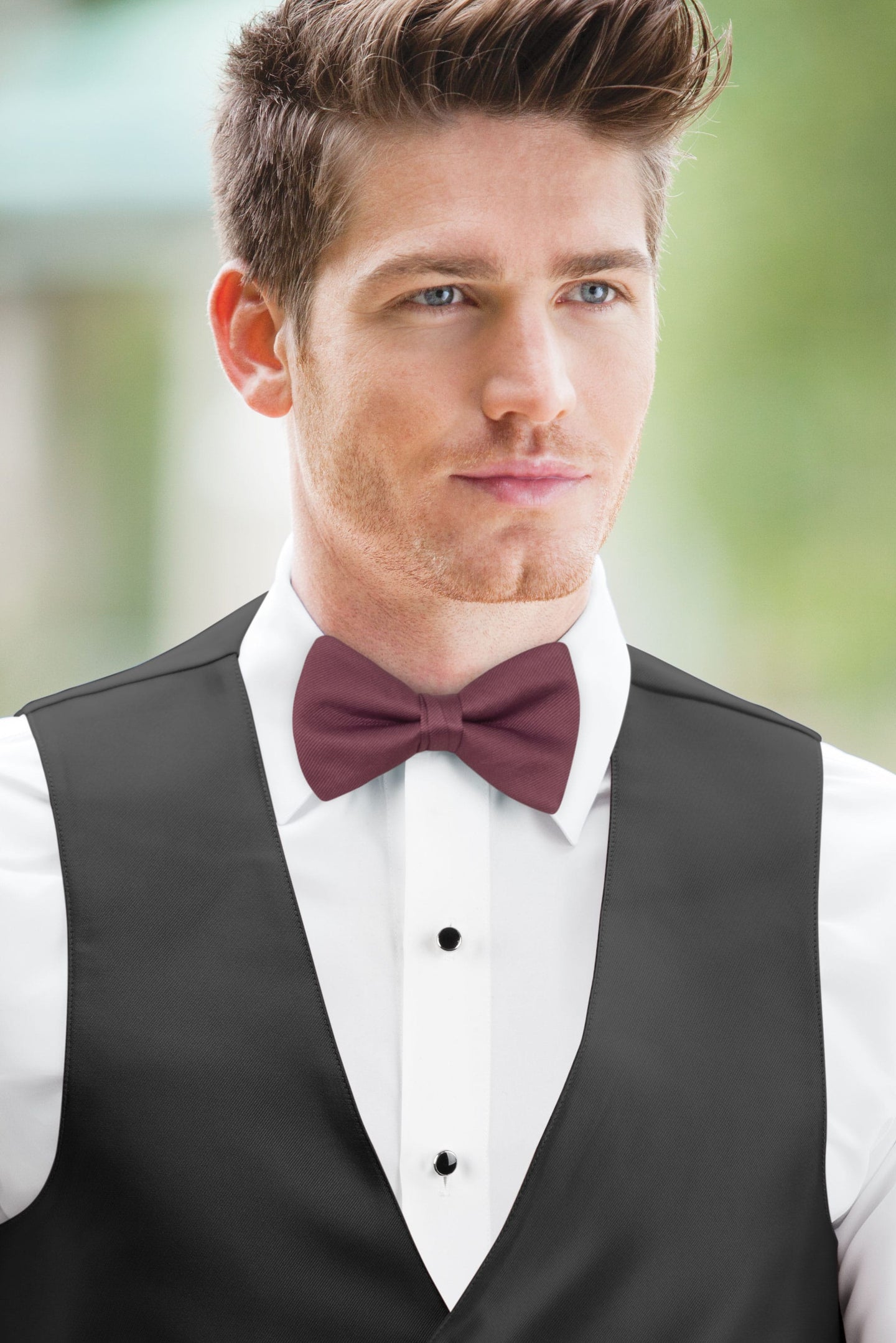 man wearing white shirt, Simply Solids rosewood bow tie, and black vest