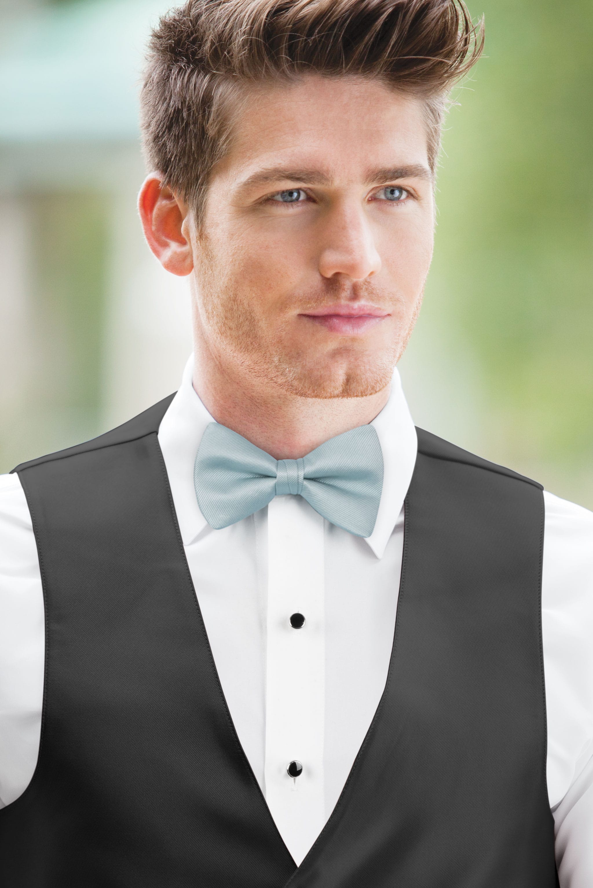 man wearing white shirt, solid sky blue bow tie, and matching Expressions vest