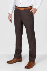Brown dress pants worn with a white shirt and brown shoes on a white background