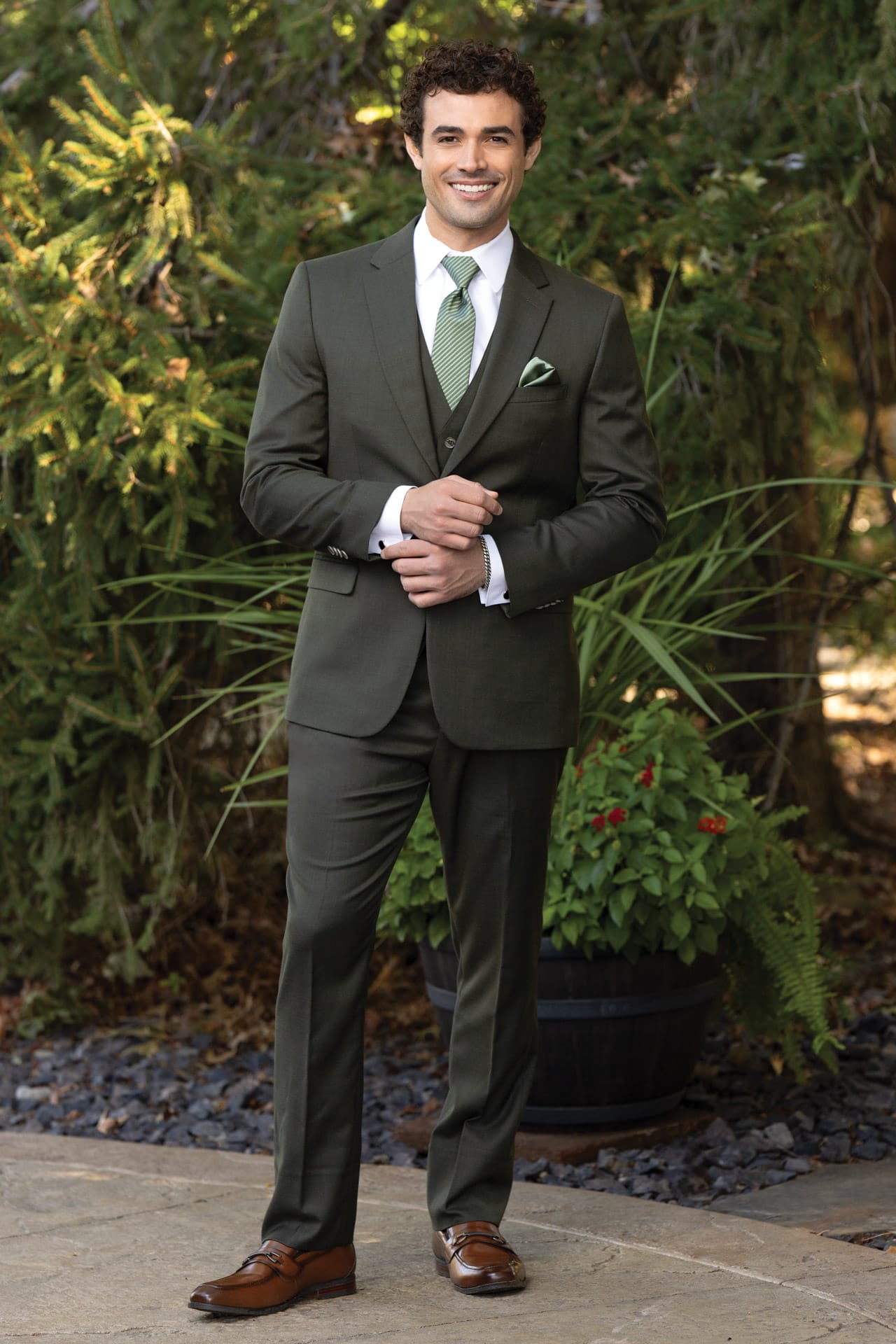 man in an olive stretch slim fit suit with a matching vest, white shirt, and light green tie