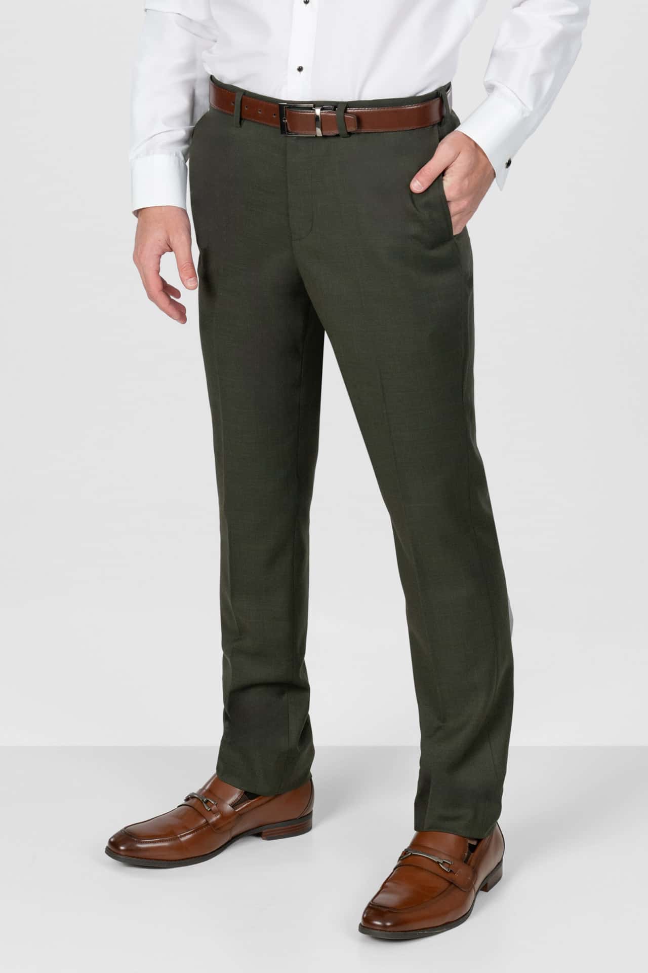 Person wearing olive green pants, white shirt, and brown shoes on a white background