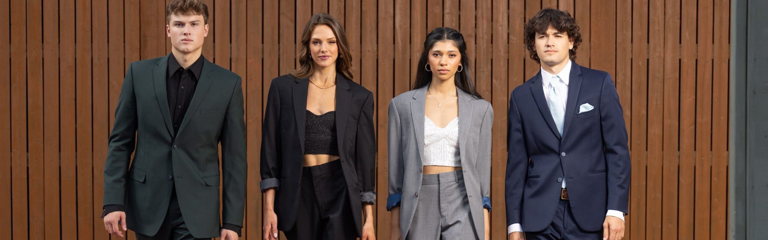 Four individuals, two men and two women, in suits.