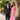 Prom kid in granite paisley tuxedo jacket with black euro slim fit pant and a bright pink bow tie standing next to his date wearing a bright pink dress with rhinestone details.