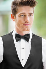 man wearing white shirt, solid black bow tie, and matching Expressions vest