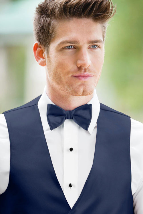 man wearing white shirt, solid navy bow tie, and matching Expressions vest