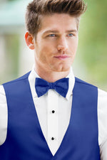 man wearing white shirt, solid royal blue bow tie, and matching Expressions vest