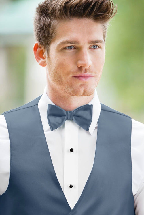 man wearing white shirt, solid slate blue bow tie, and matching Expressions vest