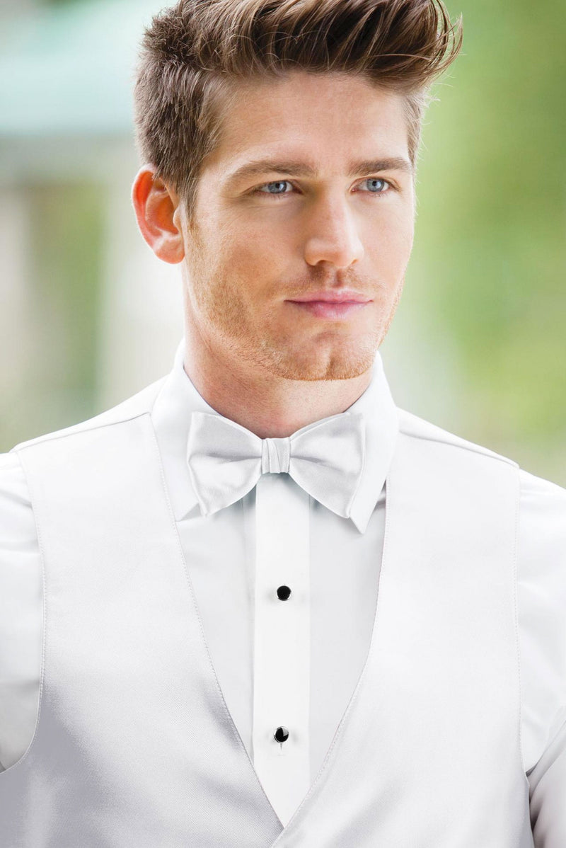 man wearing white shirt, solid white bow tie, and matching Expressions vest